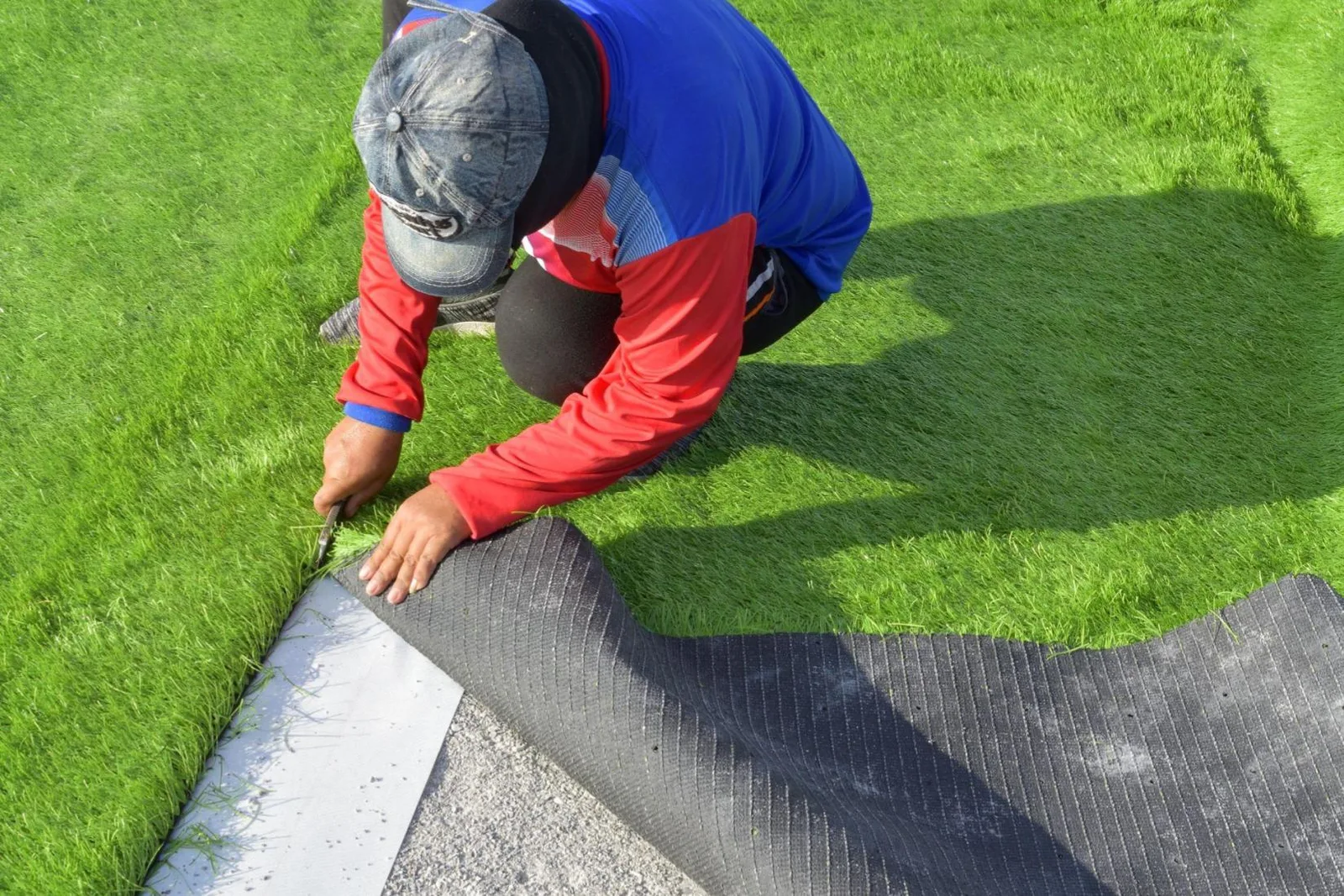 A landscaper installing artificial grass